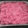 A tray filled with pink minced meat or ground beef.