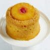 A pineapple upside-down cake with a cherry on top.