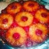 Red-colored pastry cake topped with pineapple