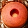 A red colored cake filled with chocolate syrup