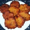 Plate of golden, crispy fried fritters.