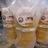 Stacked yellow corn tortillas in clear plastic packaging labeled 'Tortillas'.