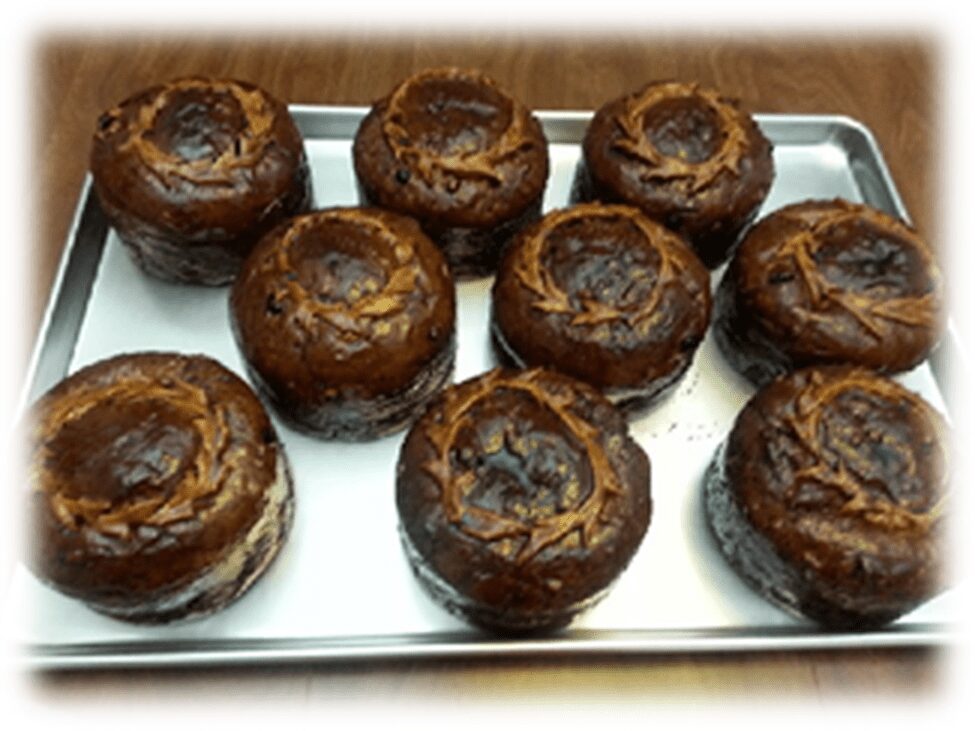 Golden fried pastries with cherry filling oozing out.