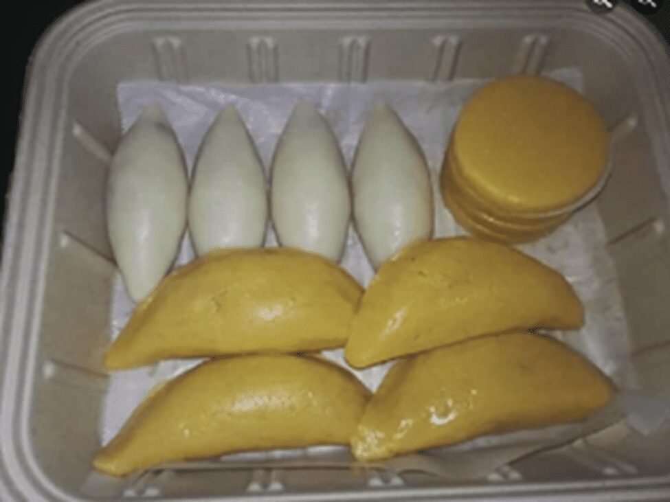 Golden fried pastries with cherry filling oozing out.