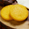 Two golden corn cakes on wooden board