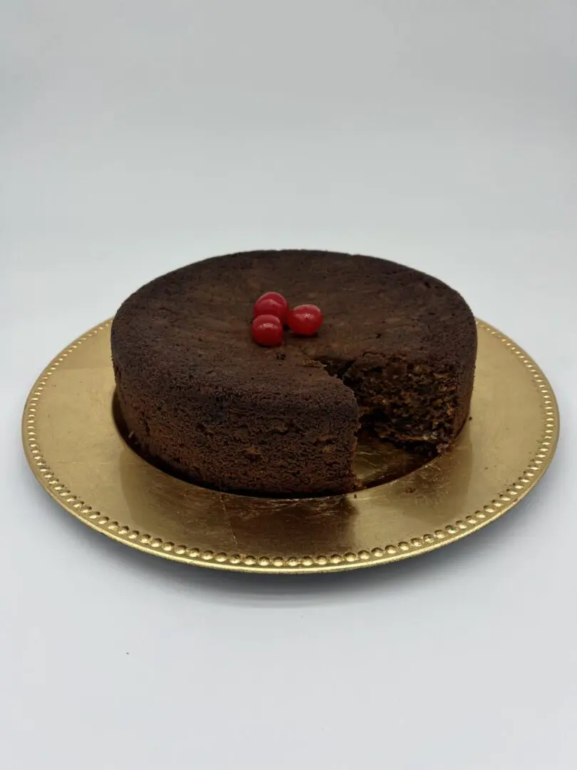 A chocolate brownie cake garnished with cherries