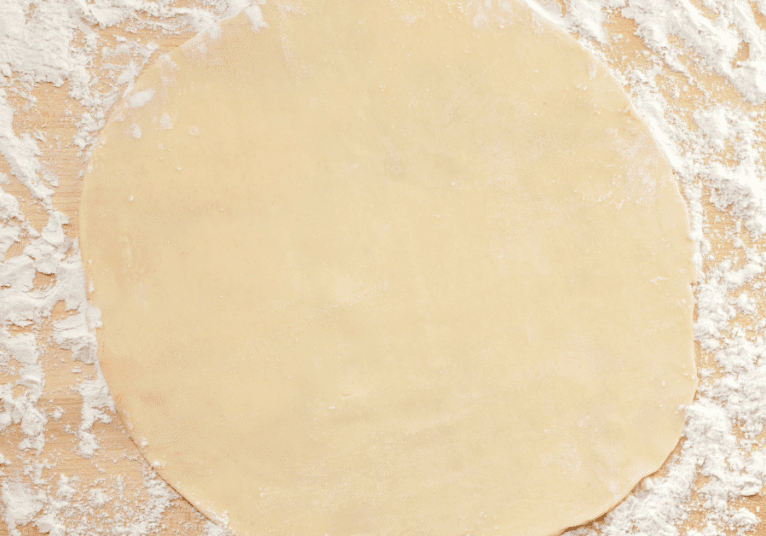 Close up image of a round unbaked chapati
