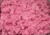 A tray filled with pink minced meat or ground beef.